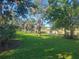 Scenic park with lush green grass and mature trees bordering a serene lake, perfect for relaxation at 318 W Crest Ave, Tampa, FL 33603