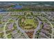 Real estate aerial showing planned community with park, pool, and lakeside views at 3257 Heart Pine Ave, Odessa, FL 33556