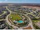 Community aerial highlighting green spaces, pool area, streets and neatly arranged homes at 3257 Heart Pine Ave, Odessa, FL 33556