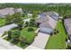 Aerial shot of a home with a well-manicured lawn, driveway, and fenced-in backyard at 3257 Heart Pine Ave, Odessa, FL 33556
