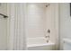 Bright bathroom featuring a white bathtub with a tile surround and shower at 3257 Heart Pine Ave, Odessa, FL 33556