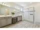Bathroom boasts a double vanity, a walk-in shower with pebble accents, and natural light at 3257 Heart Pine Ave, Odessa, FL 33556