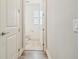 Hallway leading to a half bathroom with a tile floor at 3257 Heart Pine Ave, Odessa, FL 33556