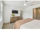Bright bedroom features a ceiling fan, a dresser and stylish decor at 3257 Heart Pine Ave, Odessa, FL 33556