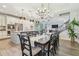 Spacious dining area with modern chandeliers, a large dining table, and hardwood floors at 3257 Heart Pine Ave, Odessa, FL 33556