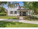 Charming two-story home showcasing a well-manicured lawn, stone accents, and a welcoming front porch at 3257 Heart Pine Ave, Odessa, FL 33556