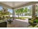 Inviting covered front porch featuring comfortable seating, stone accents, and a landscaped view at 3257 Heart Pine Ave, Odessa, FL 33556