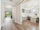 Hallway showcasing hardwood floors, office space, and open living area with natural light at 3257 Heart Pine Ave, Odessa, FL 33556