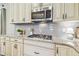 Stylish kitchen features a gas stove, granite countertops, and stainless steel microwave at 3257 Heart Pine Ave, Odessa, FL 33556