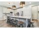 Well-lit kitchen with white cabinetry, a large granite island, and stainless-steel appliances at 3257 Heart Pine Ave, Odessa, FL 33556