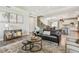 Open-concept living room featuring hardwood floors, a tray ceiling, and a combined living and dining area at 3257 Heart Pine Ave, Odessa, FL 33556
