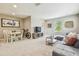 Open living area features a dining set and comfortable seating around a TV area at 3257 Heart Pine Ave, Odessa, FL 33556