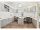 Dual workspaces with built-in cabinets, hardwood floors, and light from several windows at 3257 Heart Pine Ave, Odessa, FL 33556