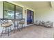 Covered patio features an outdoor seating area with a ceiling fan and brick pavers at 3257 Heart Pine Ave, Odessa, FL 33556