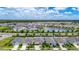 Expansive aerial view of the residential community featuring a picturesque lake at 34163 Radley Way, Wesley Chapel, FL 33545