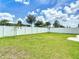 Expansive backyard featuring a lush green lawn and a white privacy fence at 34163 Radley Way, Wesley Chapel, FL 33545