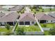 Aerial view of backyard with white fence, patio, green grass and view of the neighborhood at 34163 Radley Way, Wesley Chapel, FL 33545