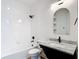 Modern bathroom with white tile, a shower-tub combo, and an elegant vanity with a marble countertop at 34163 Radley Way, Wesley Chapel, FL 33545