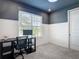 Well-lit room featuring neutral colored wall, white trim, large window and a desk at 34163 Radley Way, Wesley Chapel, FL 33545