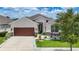 Charming single-Gathering home showcasing well-manicured lawn and inviting two-car garage at 34163 Radley Way, Wesley Chapel, FL 33545
