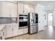 Bright kitchen showcases stainless steel appliances, modern cabinets, and stylish backsplash at 34163 Radley Way, Wesley Chapel, FL 33545