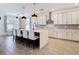 Modern kitchen boasts an island with seating, sleek appliances, and stylish pendant lighting at 34163 Radley Way, Wesley Chapel, FL 33545
