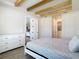 Tranquil bedroom with exposed beams, wood-look floors, and plenty of natural light at 34163 Radley Way, Wesley Chapel, FL 33545