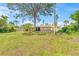 Spacious backyard featuring a well-maintained lawn and mature trees, enhancing the property's appeal at 358 Suwanee Ave, Sarasota, FL 34243