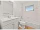 Clean white bathroom featuring a tub, vanity, and window, offering a functional and bright space at 358 Suwanee Ave, Sarasota, FL 34243