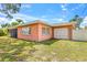 Home exterior view with a well-maintained lawn and an attached garage, showcasing curb appeal at 358 Suwanee Ave, Sarasota, FL 34243