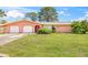 Charming single-story home with a well-maintained lawn and a two-car garage at 358 Suwanee Ave, Sarasota, FL 34243