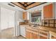 Kitchen with wooden cabinets, tile countertops and stainless steel sink, and white dishwasher at 358 Suwanee Ave, Sarasota, FL 34243
