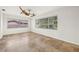 Spacious living room with natural light, tile flooring, and ceiling fan at 358 Suwanee Ave, Sarasota, FL 34243