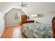 Bright bedroom with hardwood floors, a ceiling fan, and a window overlooking the yard at 39905 Townsend Rd, Dade City, FL 33525