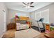 Cozy bedroom with wood flooring, ceiling fan and ample natural light from the window at 39905 Townsend Rd, Dade City, FL 33525