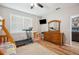 Comfortable bedroom with wood flooring, a ceiling fan and access to entertainment at 39905 Townsend Rd, Dade City, FL 33525