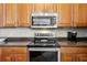Modern kitchen featuring stainless steel appliances, wood cabinets, and a sleek countertop at 39905 Townsend Rd, Dade City, FL 33525
