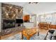 Inviting living room featuring a cozy fireplace, dining area, and comfortable seating at 39905 Townsend Rd, Dade City, FL 33525