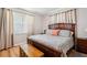 Bright main bedroom with hardwood floors, ceiling fan and natural light from the window at 39905 Townsend Rd, Dade City, FL 33525