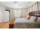 Sunny main bedroom with hardwood floors, ceiling fan and natural light from the window at 39905 Townsend Rd, Dade City, FL 33525
