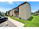 Condo building featuring well-kept landscaping, multiple units, and parking area in a desirable neighborhood at 4215 E Bay Dr # 1801E, Clearwater, FL 33764