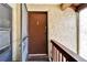 A solid, brown front door with secure deadbolt, on a stucco exterior at 4215 E Bay Dr # 1801E, Clearwater, FL 33764