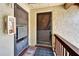 Brown front door of home with metal screen door and decorative pineapple welcome mat at 4215 E Bay Dr # 1801E, Clearwater, FL 33764
