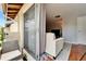 View from outdoor balcony into the living room with contemporary couch at 4215 E Bay Dr # 1801E, Clearwater, FL 33764