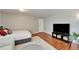 Bright living room with hardwood floors, television, and decorative touches creating a comfortable atmosphere at 4215 E Bay Dr # 1801E, Clearwater, FL 33764
