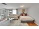 Cozy and well-lit room featuring a sofa, bed, and a view of the outdoors providing comfort at 4215 E Bay Dr # 1801E, Clearwater, FL 33764