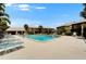 Community pool with plenty of lounge chairs and well-maintained landscaping for a relaxing atmosphere at 4215 E Bay Dr # 1801E, Clearwater, FL 33764