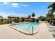 A view of the inviting community pool, surrounded by lush landscaping and plenty of lounge chairs at 4215 E Bay Dr # 1801E, Clearwater, FL 33764