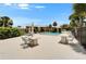 Community pool area with tables and chairs offering a relaxing outdoor space for residents at 4215 E Bay Dr # 1801E, Clearwater, FL 33764