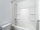 Clean bathroom featuring a tub with a shower, complemented by bright and neutral tones at 4338 Banjo Lake Rd, Land O Lakes, FL 34639